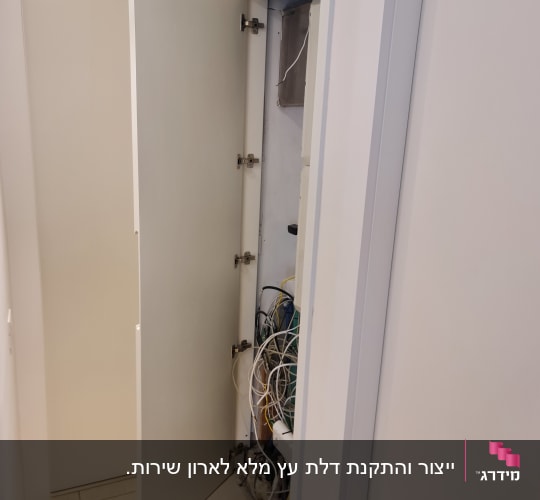 ארון פתוח עם חוטי חשמל גלויים
